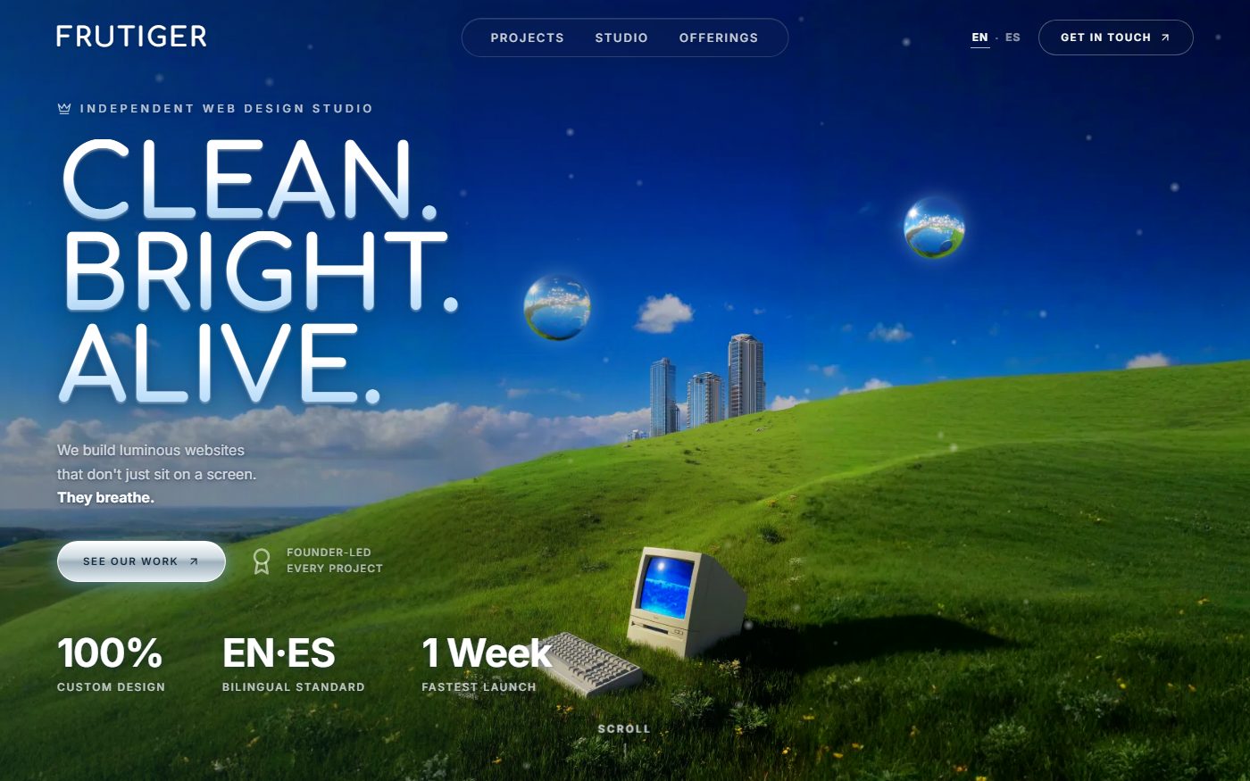 Screenshot of the frutiger.studio hero: glossy heading over a green hill with chrome spheres